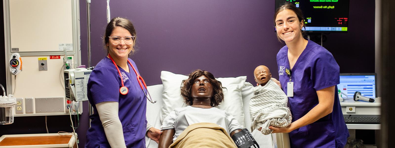 group of nursing students in simulation lab practicing listening to mannequin's heartbeat